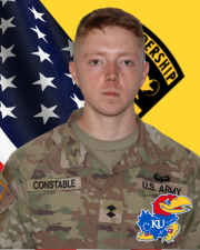 CDT Constable standing in front of the American flag and Cadet Command Flag