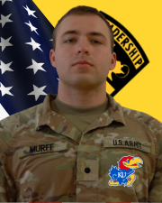 CDT Murff standing in front of the American flag and Cadet Command Flag