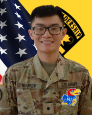 CDT Nguyen standing in front of the American flag and Cadet Command Flag