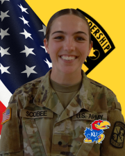 CDT Scobee standing in front of the American flag and Cadet Command Flag