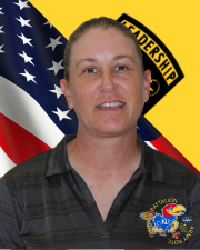 Ms. Richter standing in front of the American flag and Cadet Command Flag